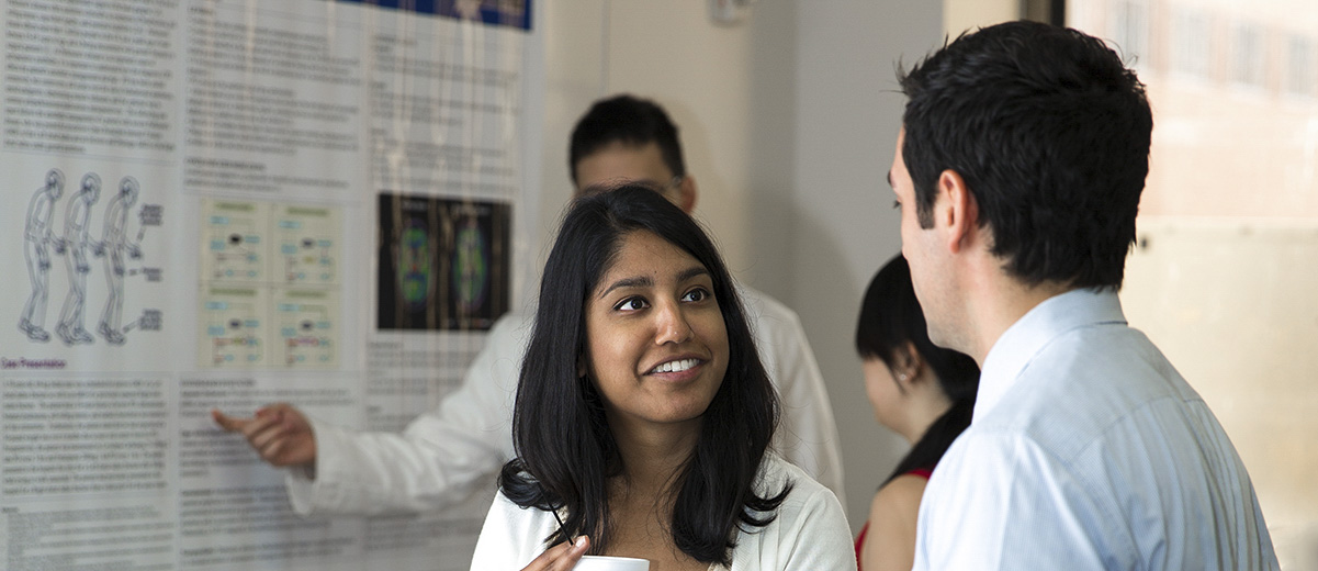 Residents discussing posters at CA-1 research symposium 2013