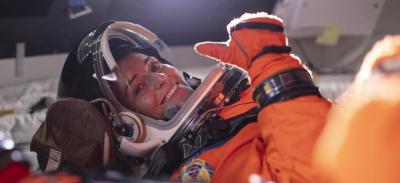 NASA astronaut Nicole Mann gives a thumbs up from inside the Orion spacecraft mockup.