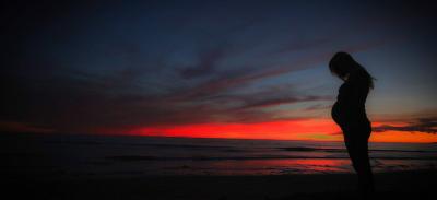Pregnant woman at sunset