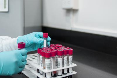 Close up of hands handling blood sample tubes