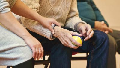 Elderly hands holding a ball