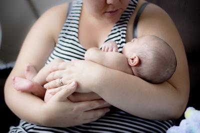 Photograph of mom holding newborn baby.