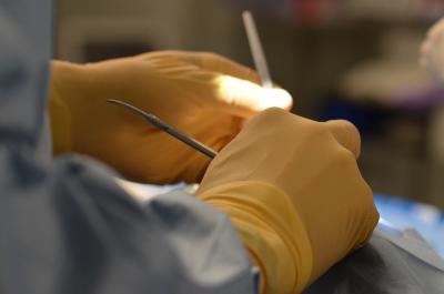 Close up photo of gloved hands performing surgery