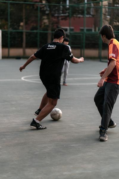 Photo of people playing soccer on a basketball court