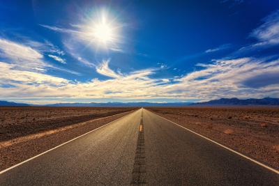 Photo of an empty road to represent a road trip and traveling
