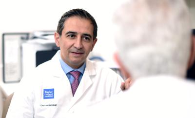 Dr. Hashim El-Serag speaking with colleague