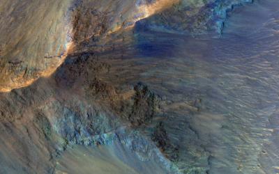 This image captures some of the geologic diversity of Mars. There are hills of ancient terrains on the floor of Juventae Chasma, surrounded by younger sediments, including dark sand sheets and dunes that are likely active today.