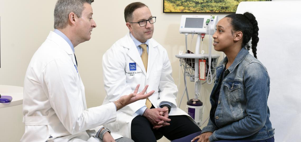 Endocrine surgeons talking with patient
