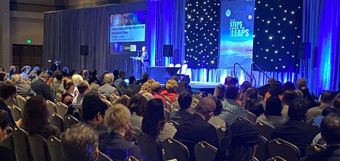 An audience listening to a speaker during the NASA's Human Research Program.