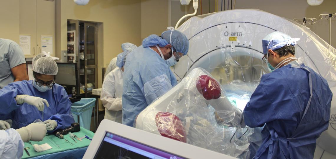 Faculty and fellows performing neurosurgery