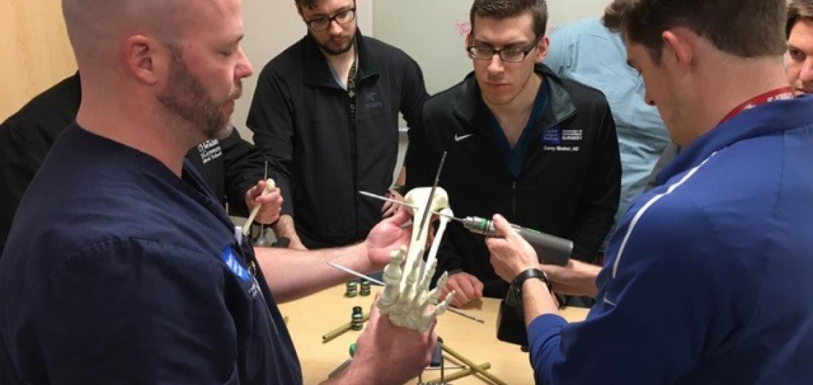 Orthopedic residents practicing surgical skills.