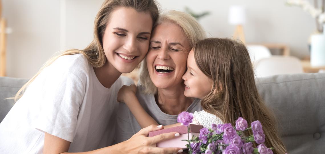 A family of three females hugging. 