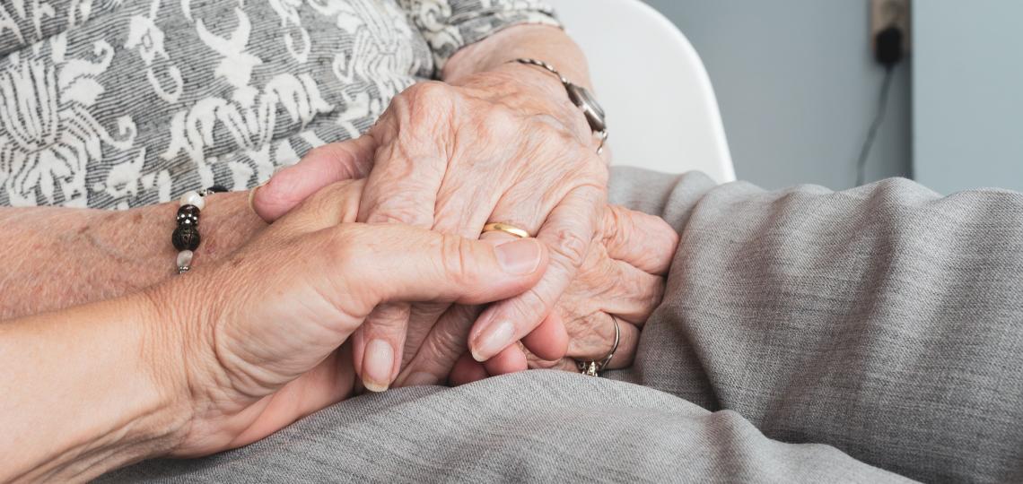 elderly family member holding hands