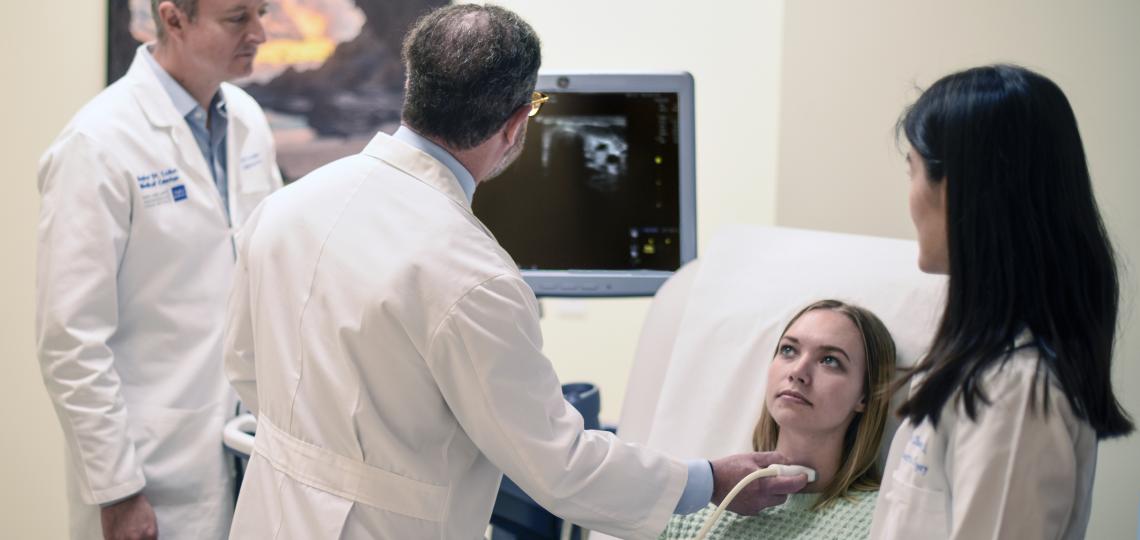 Drs. Suliburk, Grogan, and Zheng performing a fine needle aspiration biopsy on a patient.