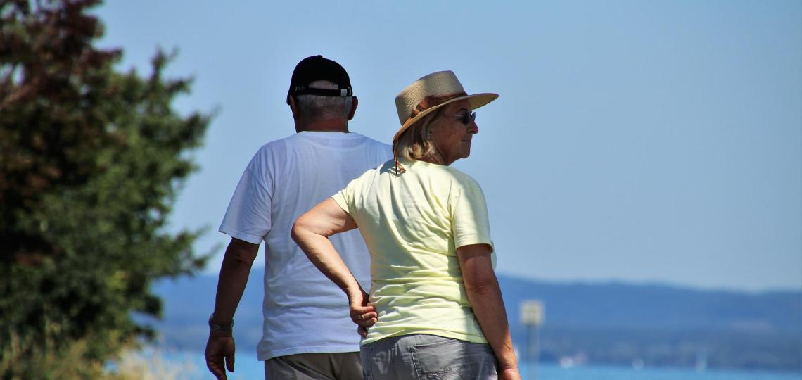 Older couple walking in the shade