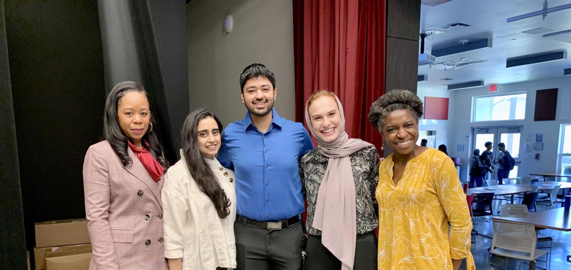 Five people smiling for the camera during a Chinquapin Preparatory School event