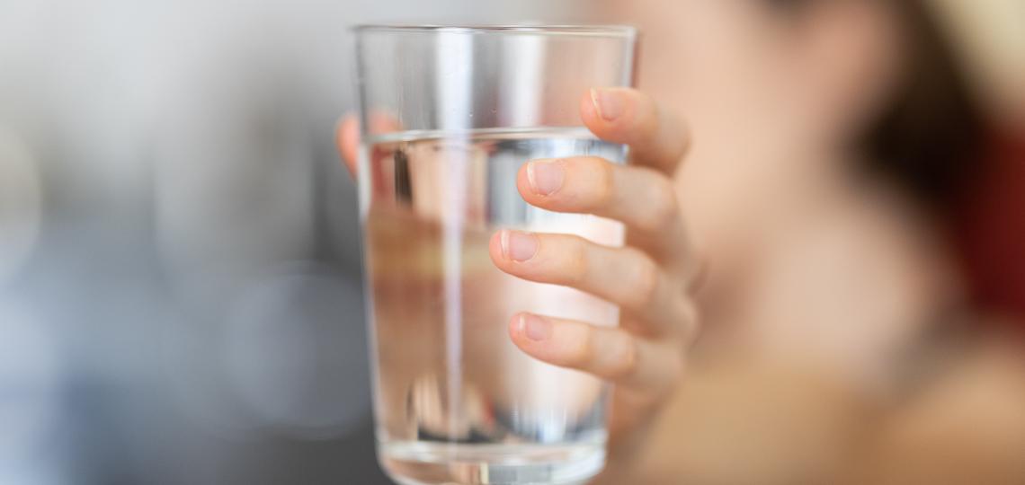 Woman holding water glass