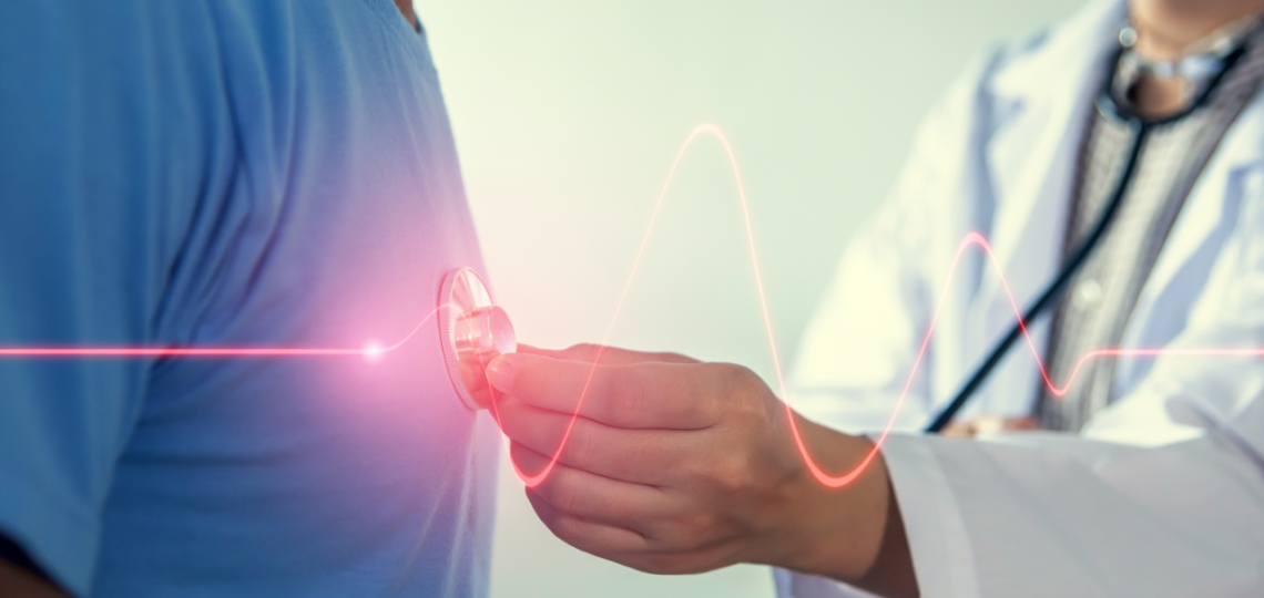 Doctor using a stethoscope to listen to patient's heart, graphic of heart beat displayed over image with red line. 