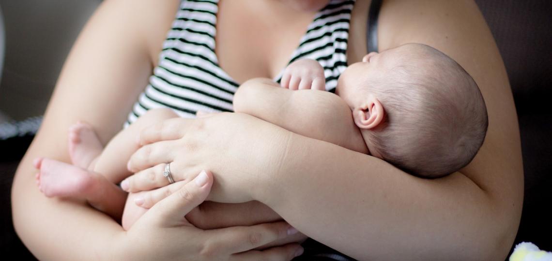 Photograph of mom holding newborn baby.