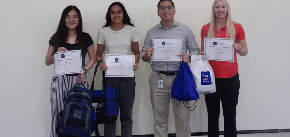 Four students holding their certificates