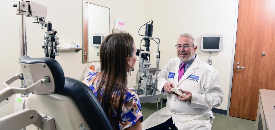 An eye doctor consulting with a patient.