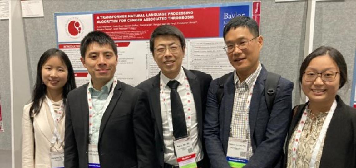 Group of people standing in front of a poster