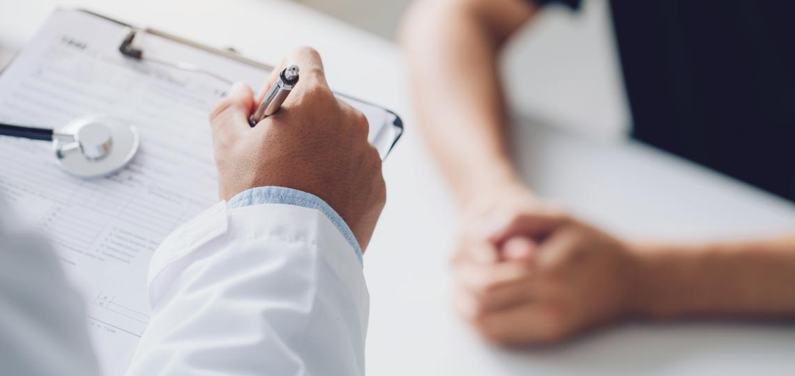 A doctor adding information to a chart.