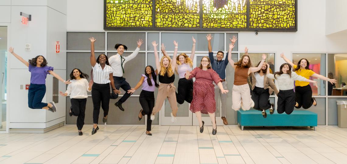group of people jumping in the air and smiling