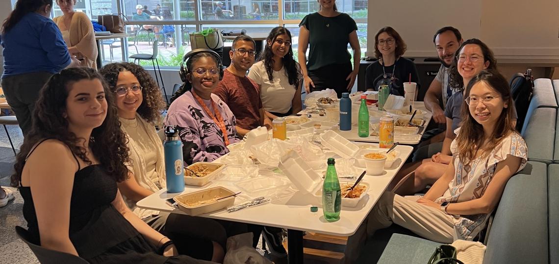 large group of people sitting at a table in a restaurant