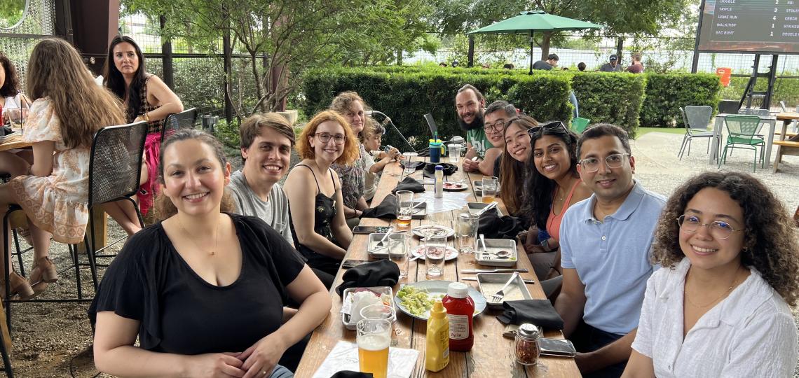 people sitting at a table outside