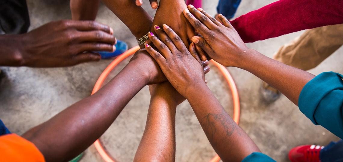 hands stacked together in uniformity