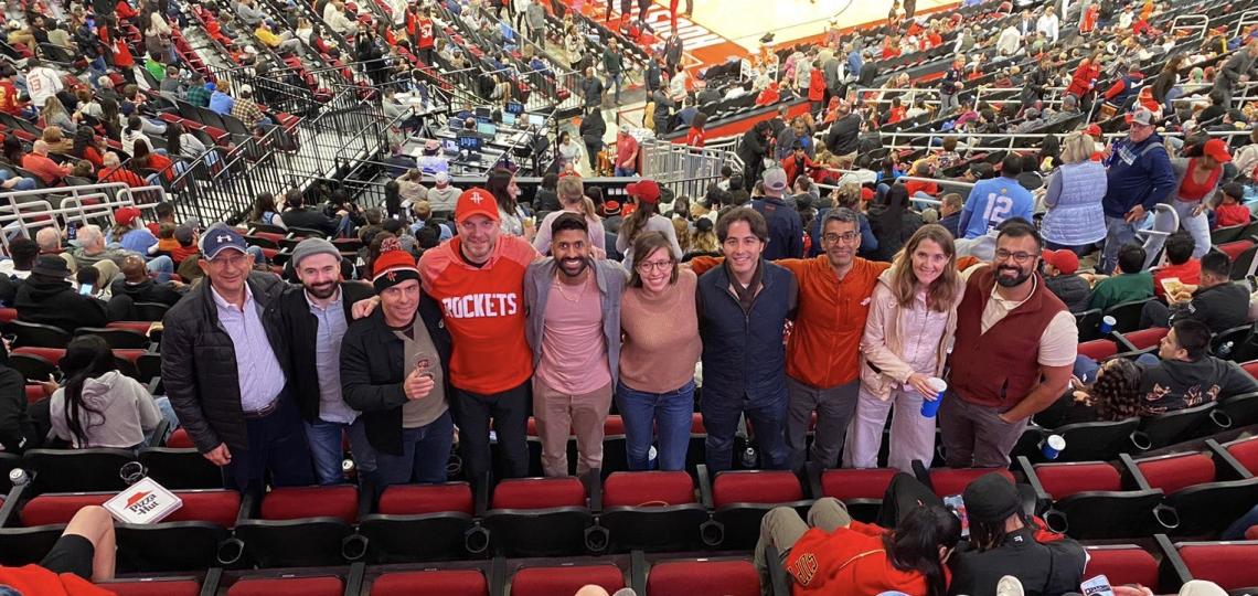 group of people smiling and standing in a stadium