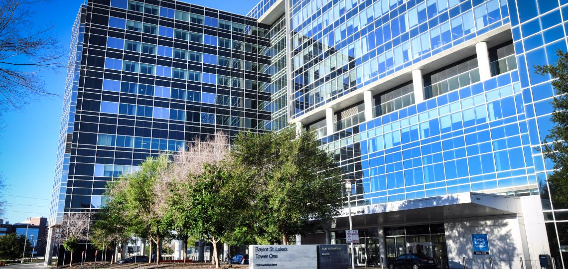 Baylor St. Luke's Tower One, a large windowed building with a blue sky behind it.