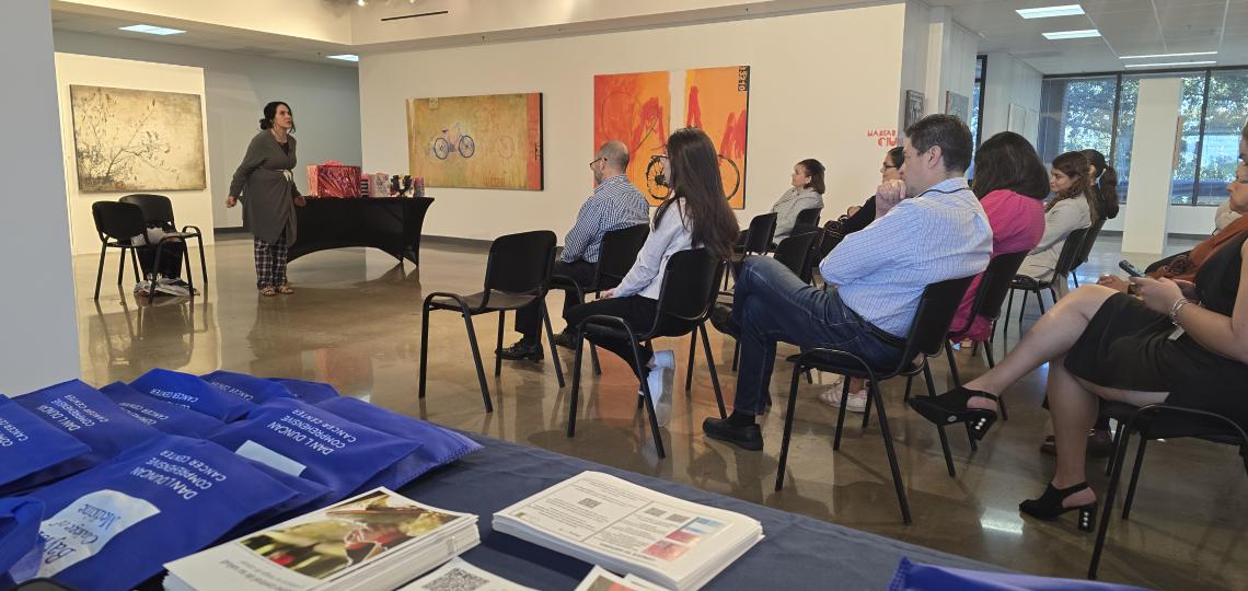 people sitting in chairs watching a woman perform theater show