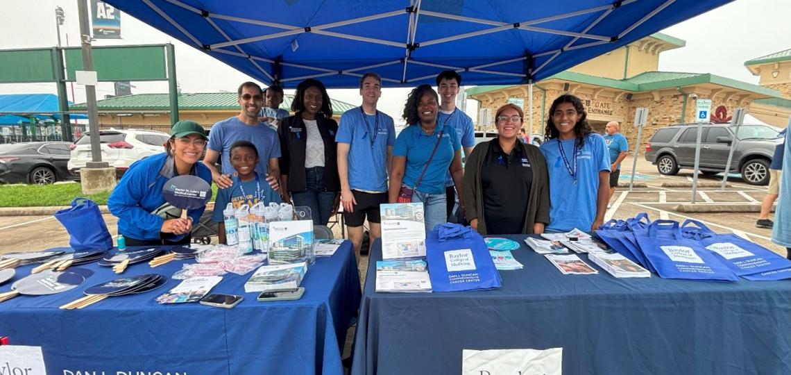 group of people smiling at BCM volunteer tables