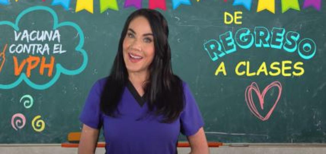 woman standing in front of a chalkboard with colorful writing on it