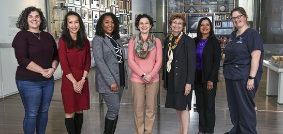 Seven people standing side-by-side 