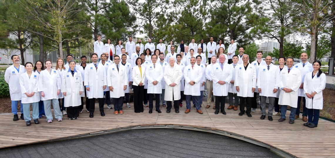 large group of doctors standing together smiling