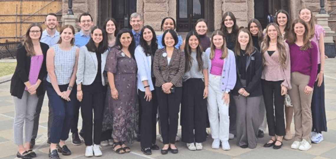 A group of genetic counseling students standing in front of the Texas state capital.