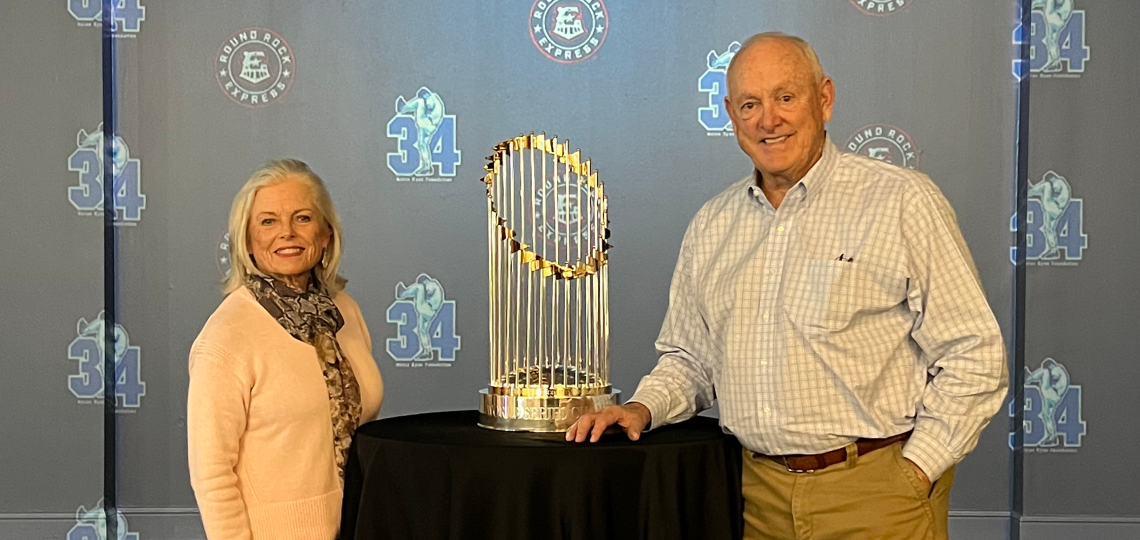 Nolan Ryan and his wife, Ruth, pose with a World Series trophy.