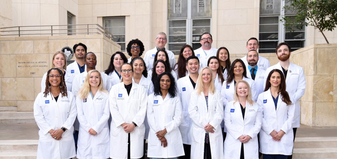 group of doctors standing together outside, smiling