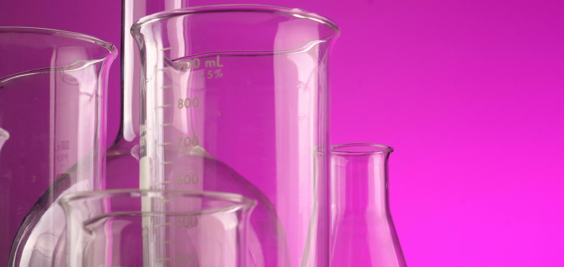 Photo of test tubes with a pink background