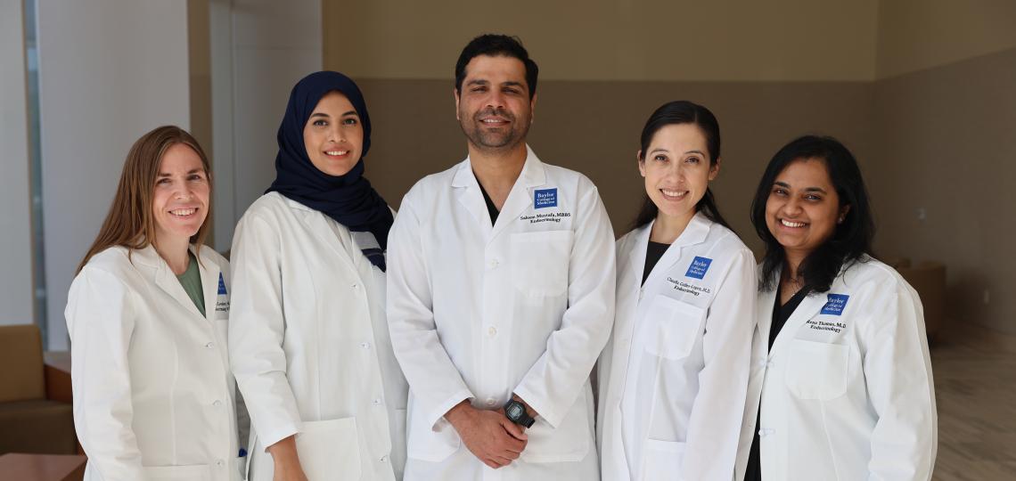 5 doctors standing together, smiling