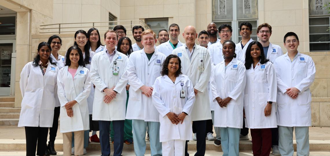 group of doctors standing on stairs and smiling