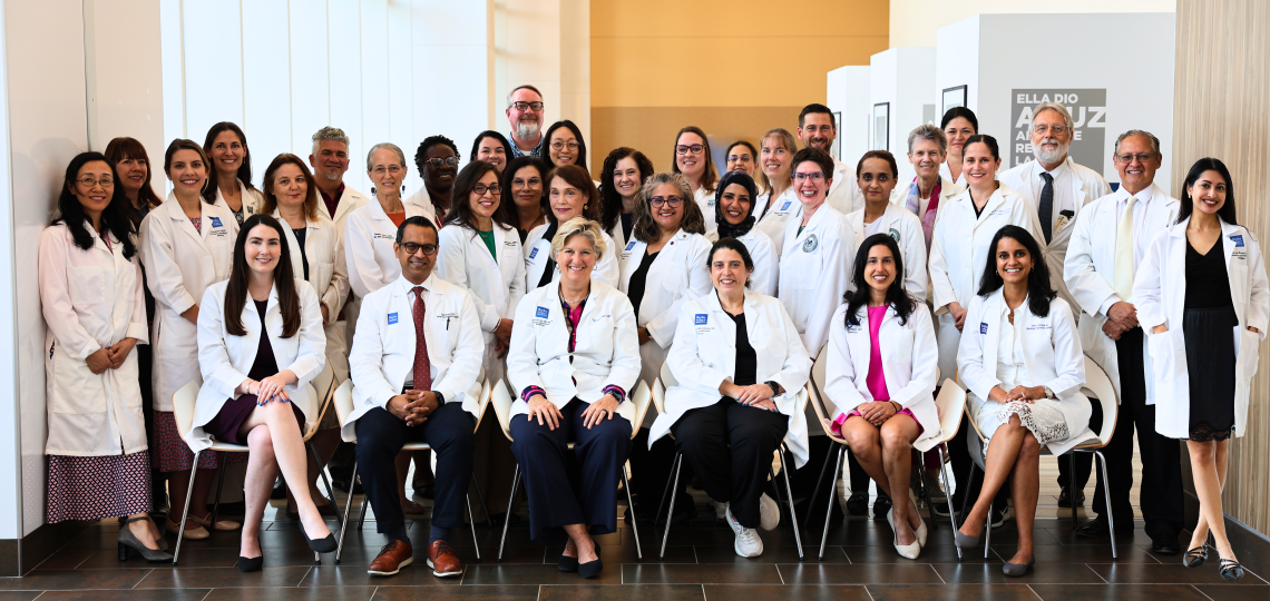 a group of people in white coats sitting and standing