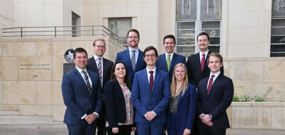 group of people in business attire smiling