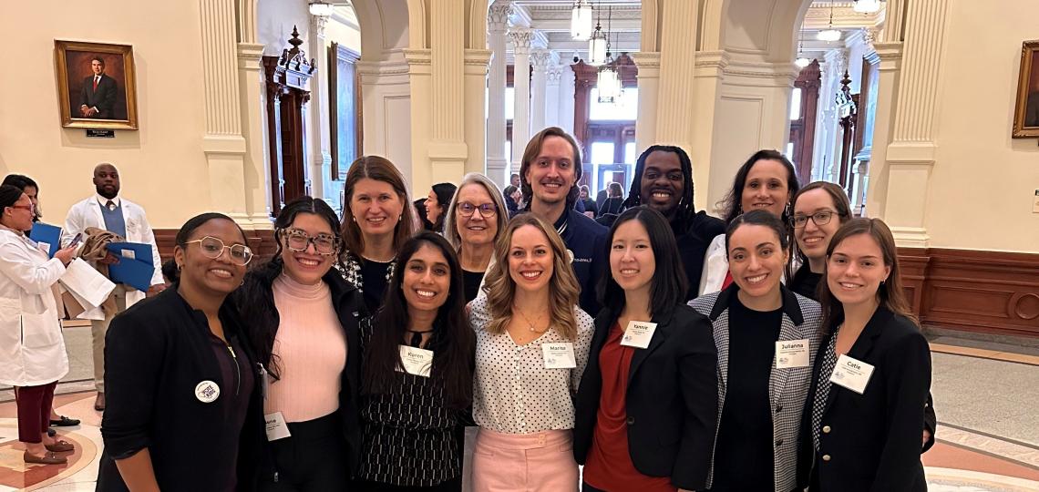group of people dressed in business attire, smiling