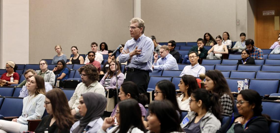 man standing in an auditorium of people sitting
