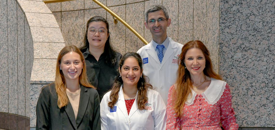 Group of people standing in front of stairs