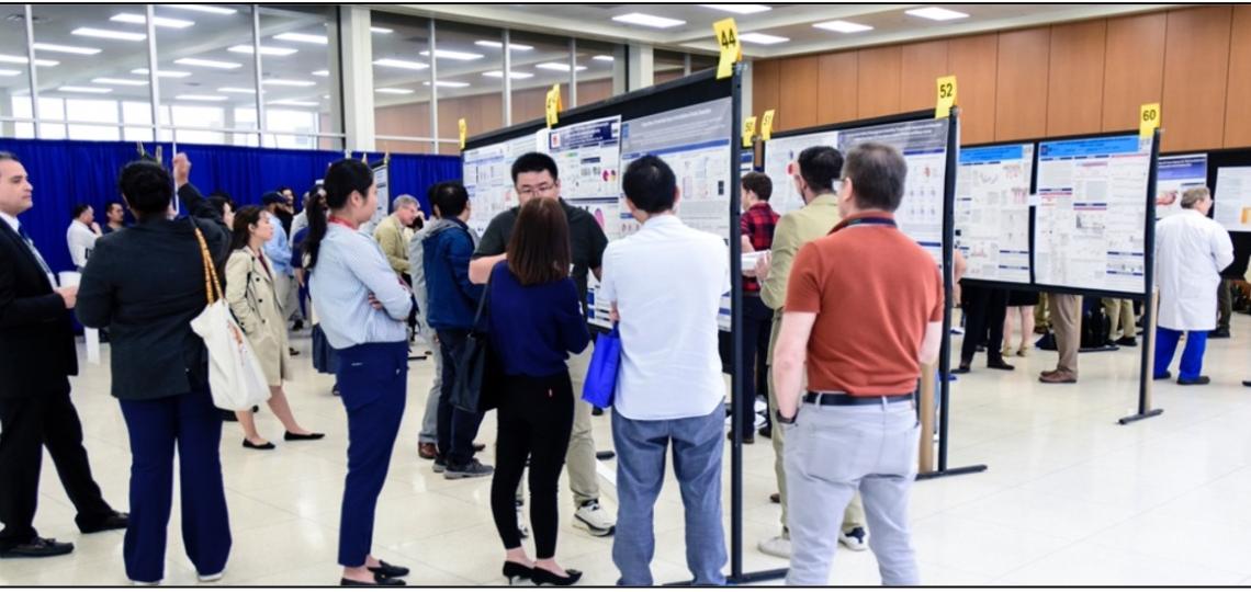people browsing through medical poster boards